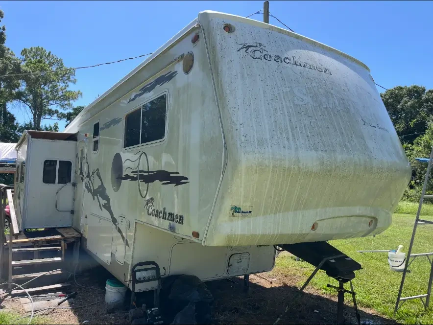 Stained Coachmen RV exterior before Van-Van detailing